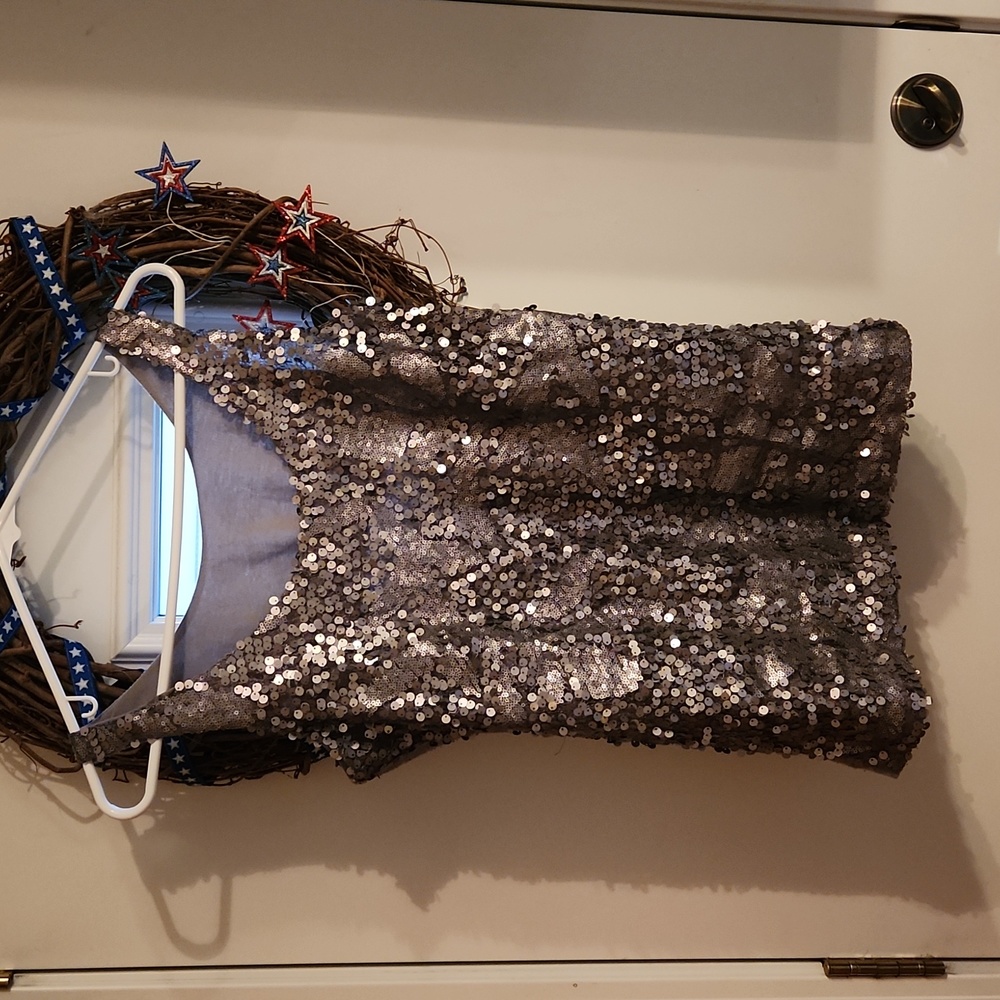 Gray sequined tank, soft material on back, no tags, but I believe it is medium.